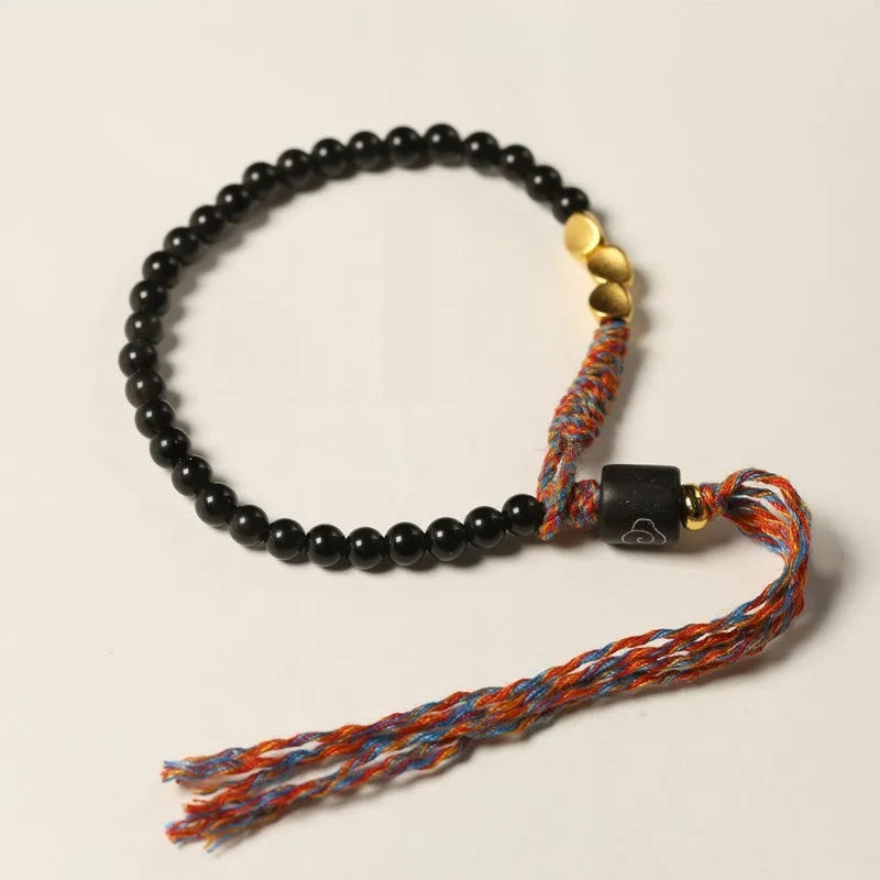 Hand-woven obsidian black wrist strap showing 4mm width and natural cord texture