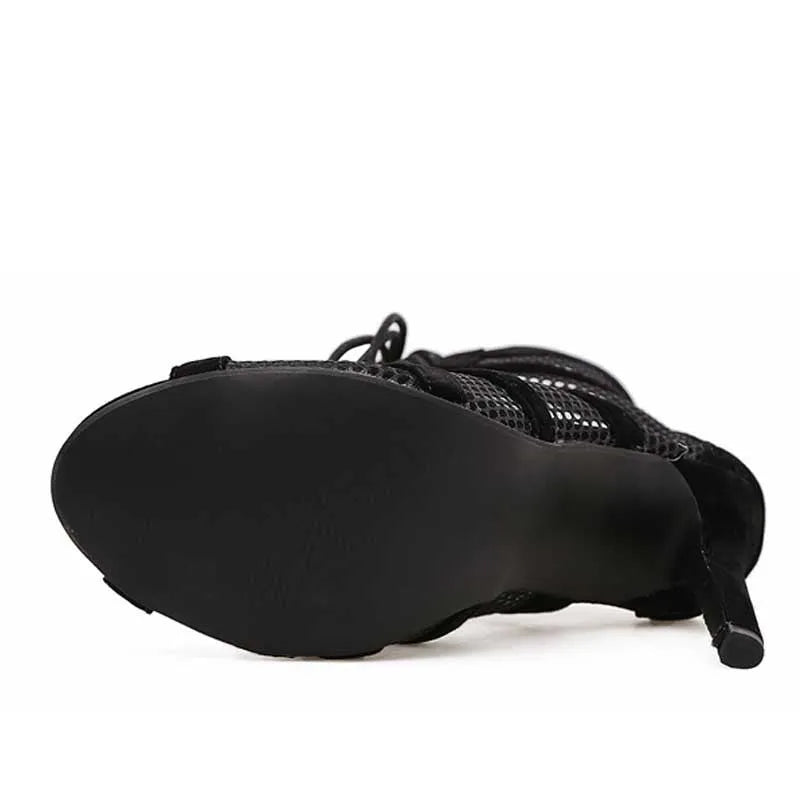 Black suede women's lace-up high heel shoes showing ankle strap and 11.5 cm heel.