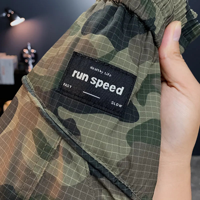 Men's camouflage cargo shorts in a loose fit with cargo pockets and elastic waist.