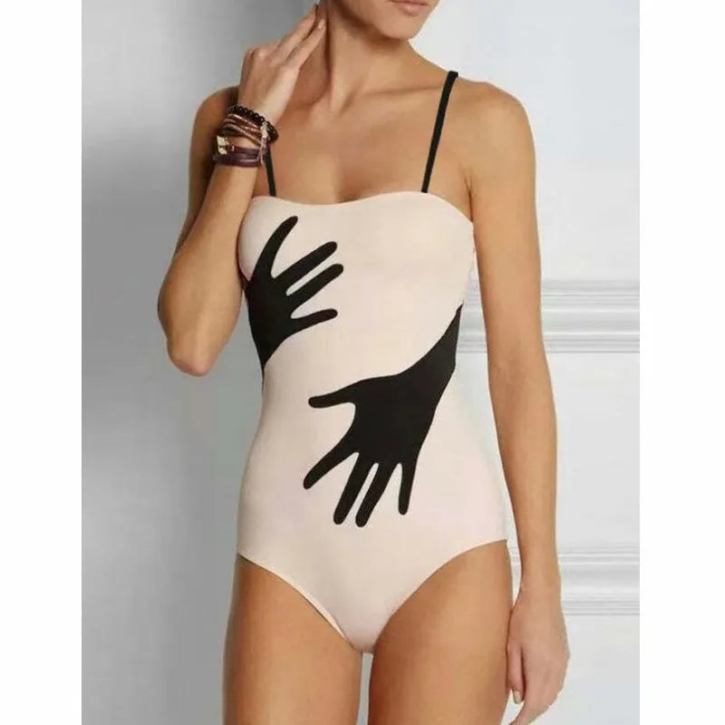 Women's patterned one-piece bikini swimsuit with a separate white tulle skirt laid flat.