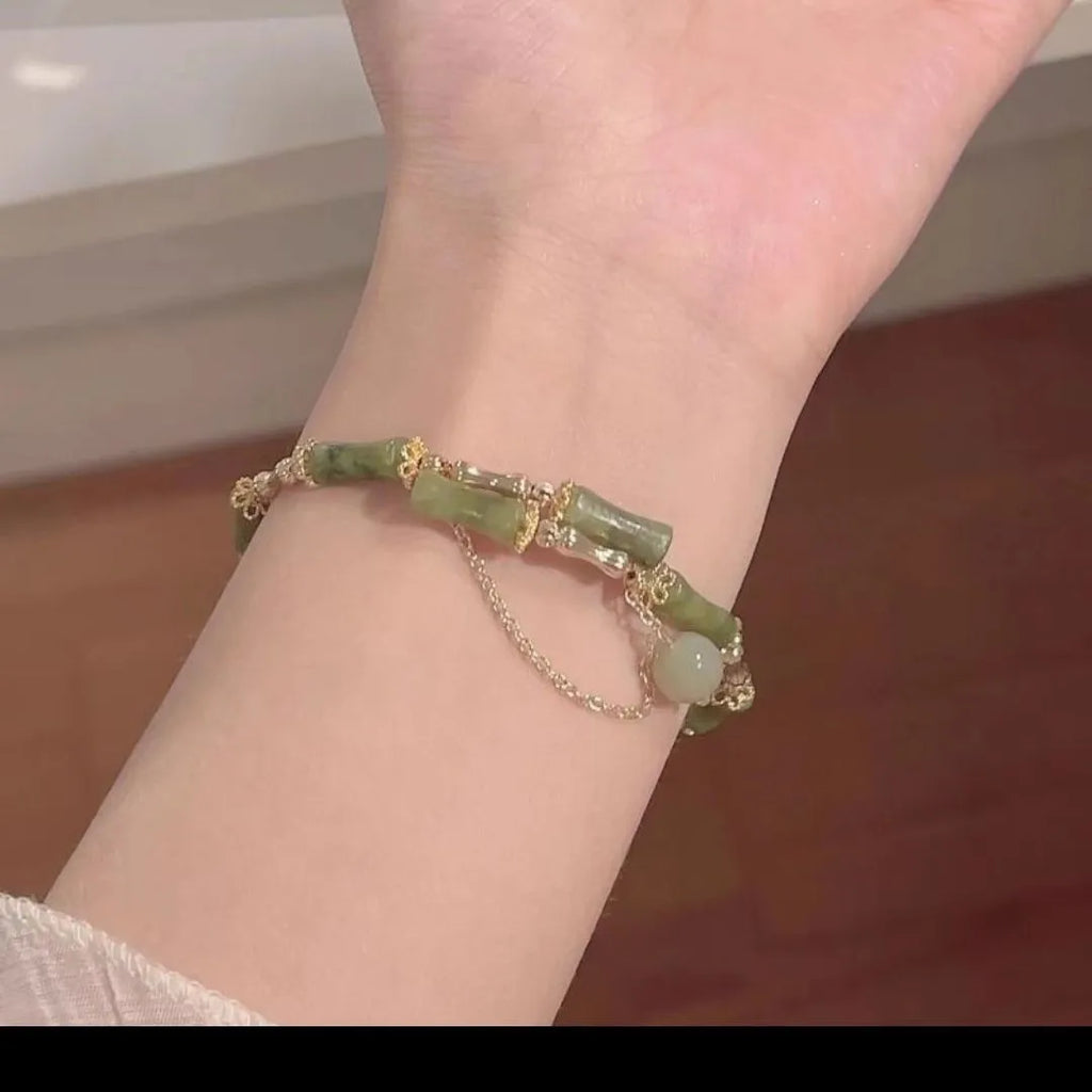 Women's bamboo bracelet with coloured glaze beads in plum wine colour featuring bamboo joint design