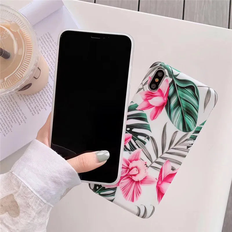 Pink floral pattern TPU back cover case for iPhone on a table.