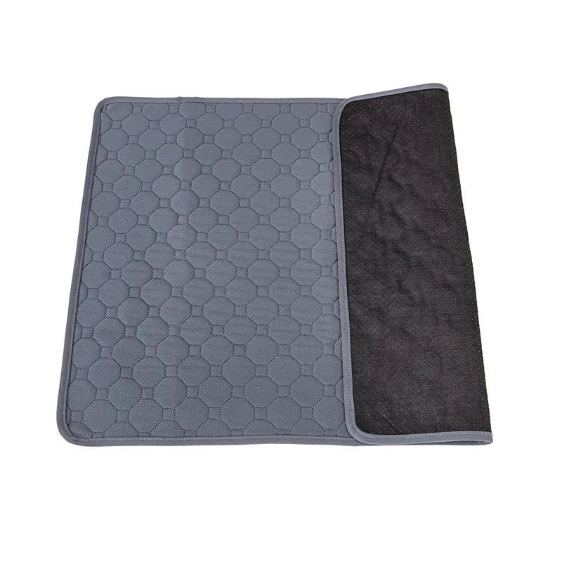 Set of two neutral-coloured washable dog pee pads on a wooden floor.