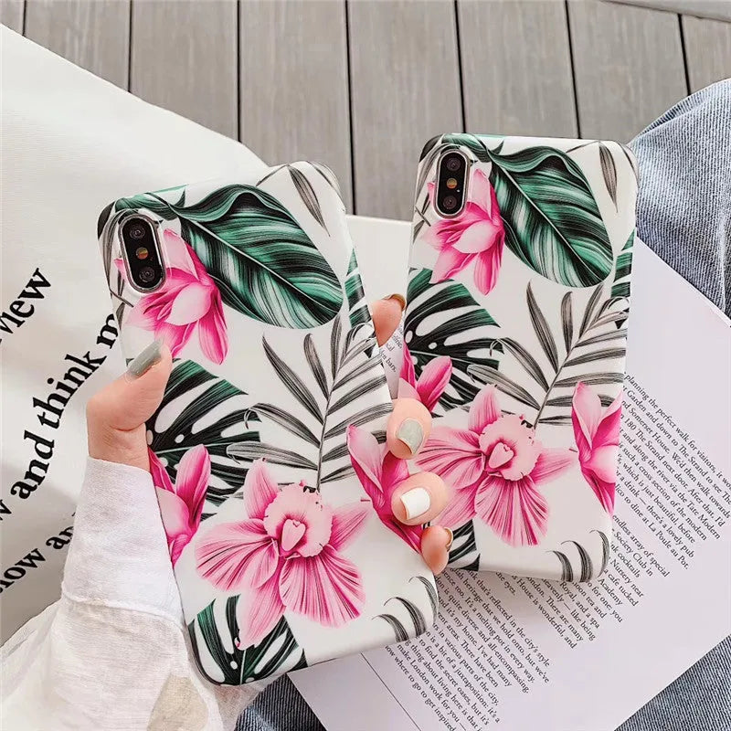 Pink floral pattern TPU back cover case for iPhone on a table.
