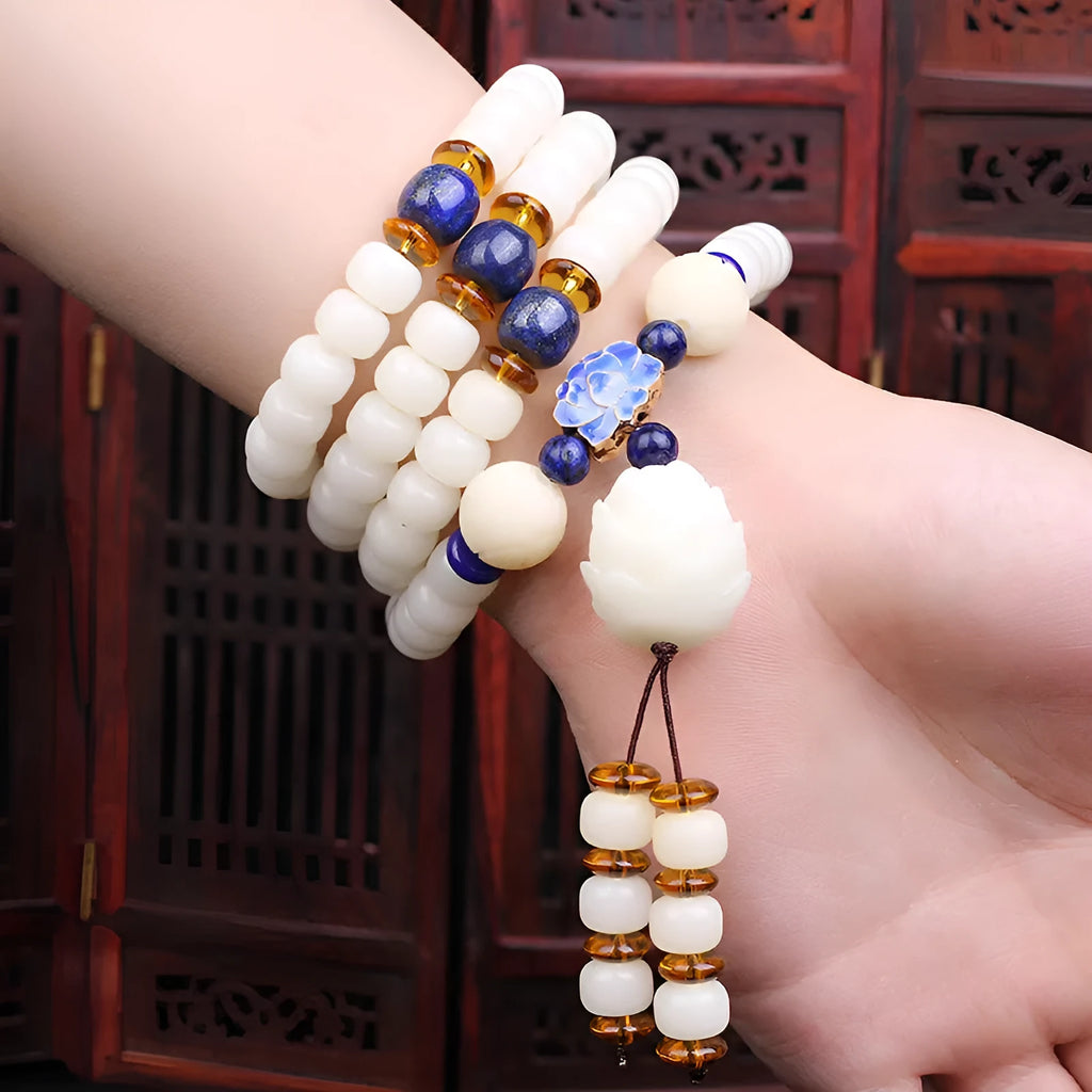 White jade bodhi bead long bracelet showing 6x8mm beads in a cloisonne style design.