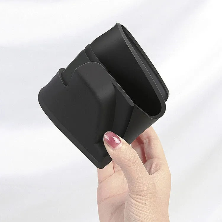 Black silicone glasses storage case accessory installed in a Tesla Model 3 or Y centre console armrest.
