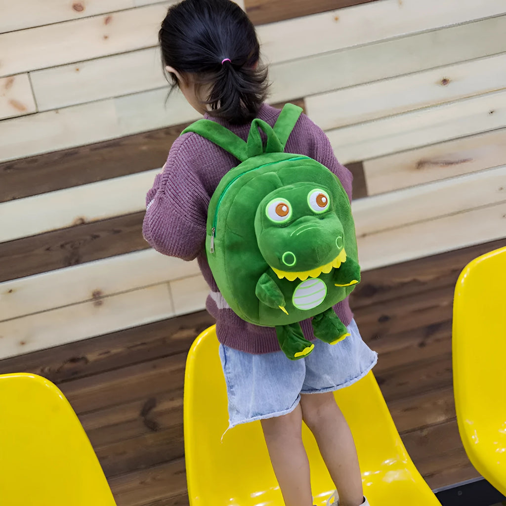 Blue dinosaur plush backpack for children with embroidery, soft handle, and polyester lining.