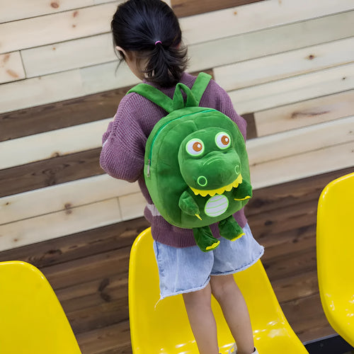 Blue dinosaur plush backpack for children with embroidery, soft handle, and polyester lining.