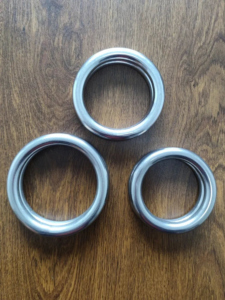 A silver-coloured carbon steel Wing Chun training ring for martial arts strength conditioning.