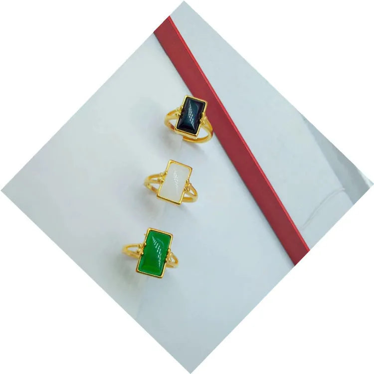 Adjustable brass electroplated ring with gold plating and embedded gemstones in black, green or white options