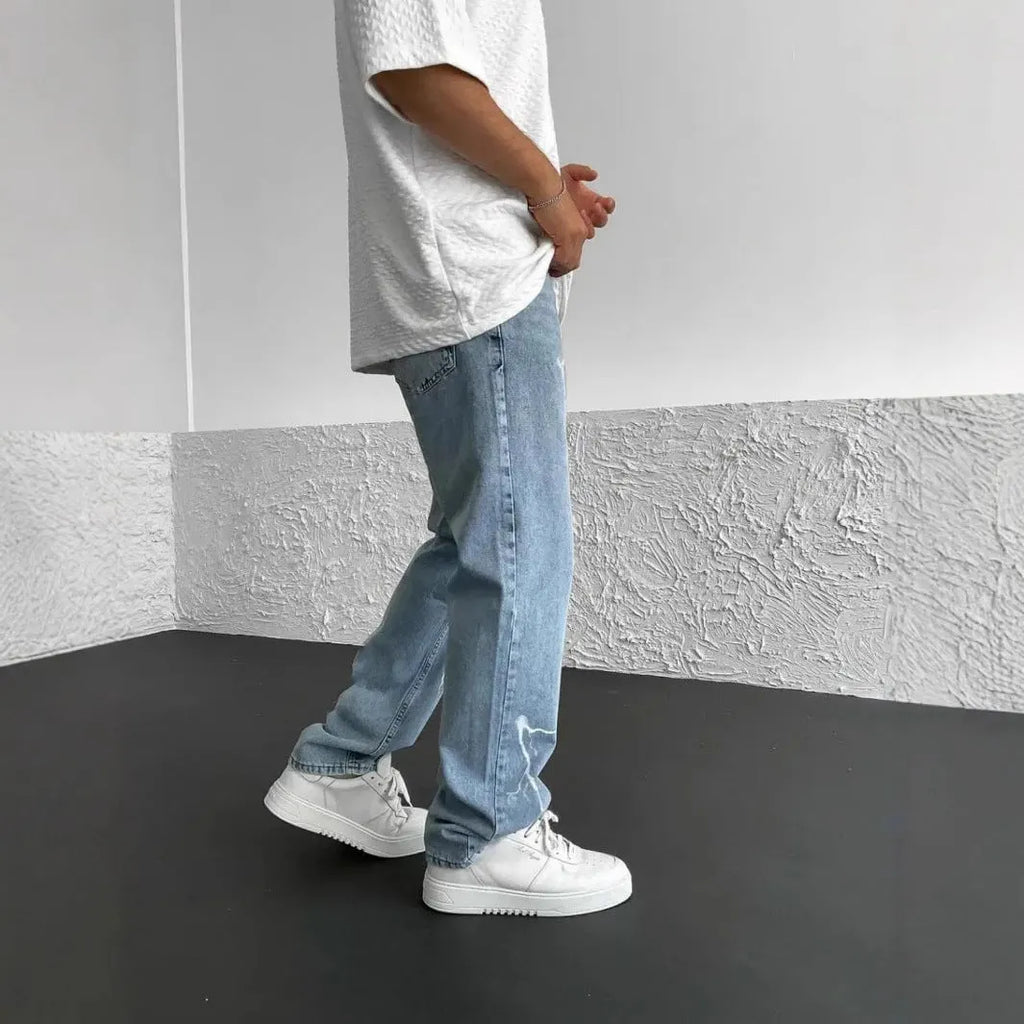 Men's blue straight-leg loose wide-leg denim jeans on a neutral background