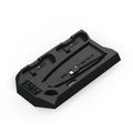 Black PS5 charging base stand holding a console upright with two wireless controllers charging in slots.