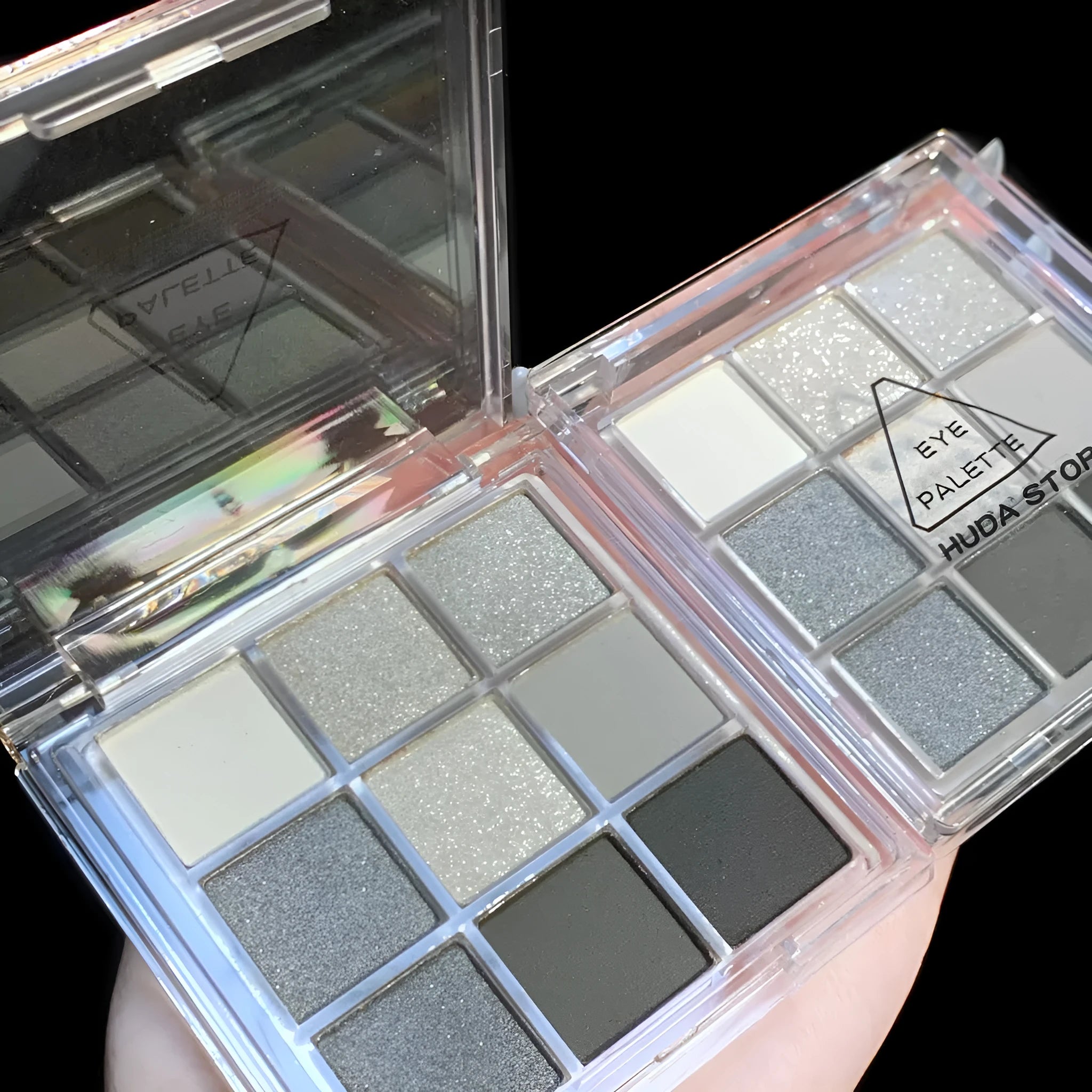 INS-style nine-color eyeshadow palette open, showing white, silver, black, and iron grey pressed powder shades.