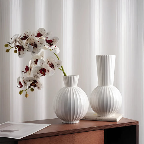 White ceramic ball striped vase in American country style on table with orchid arrangement