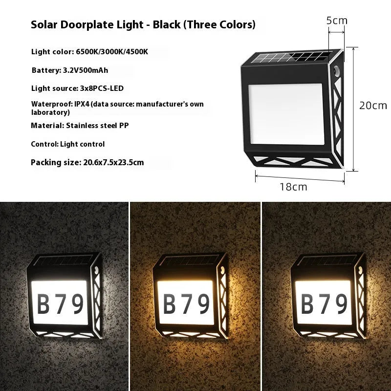 Black solar powered doorplate light with digital LED display mounted on brick wall