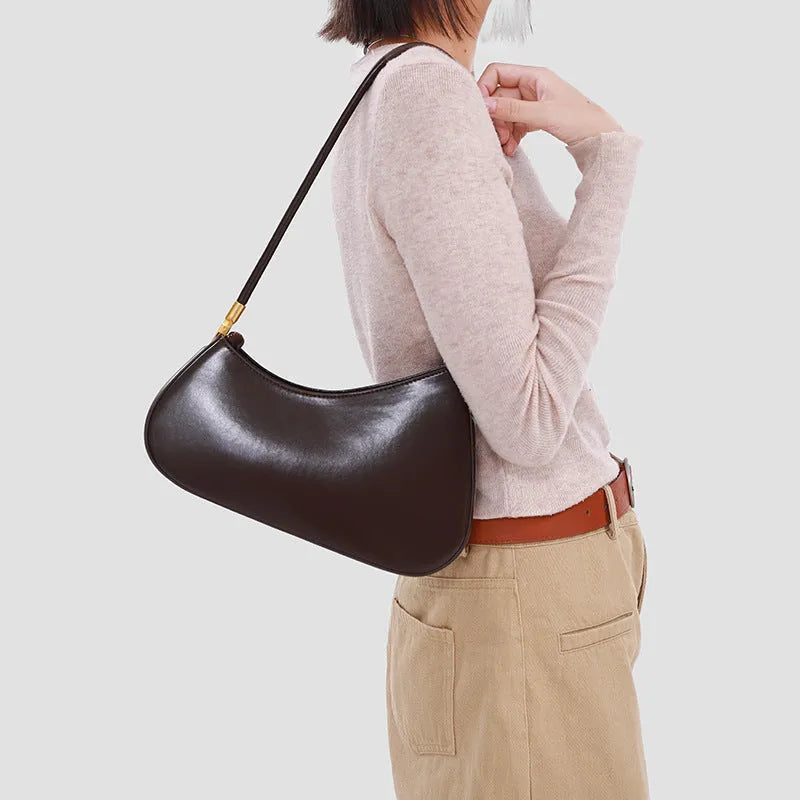 Women's oval underarm handbag in PU material with single strap and zippered compartment