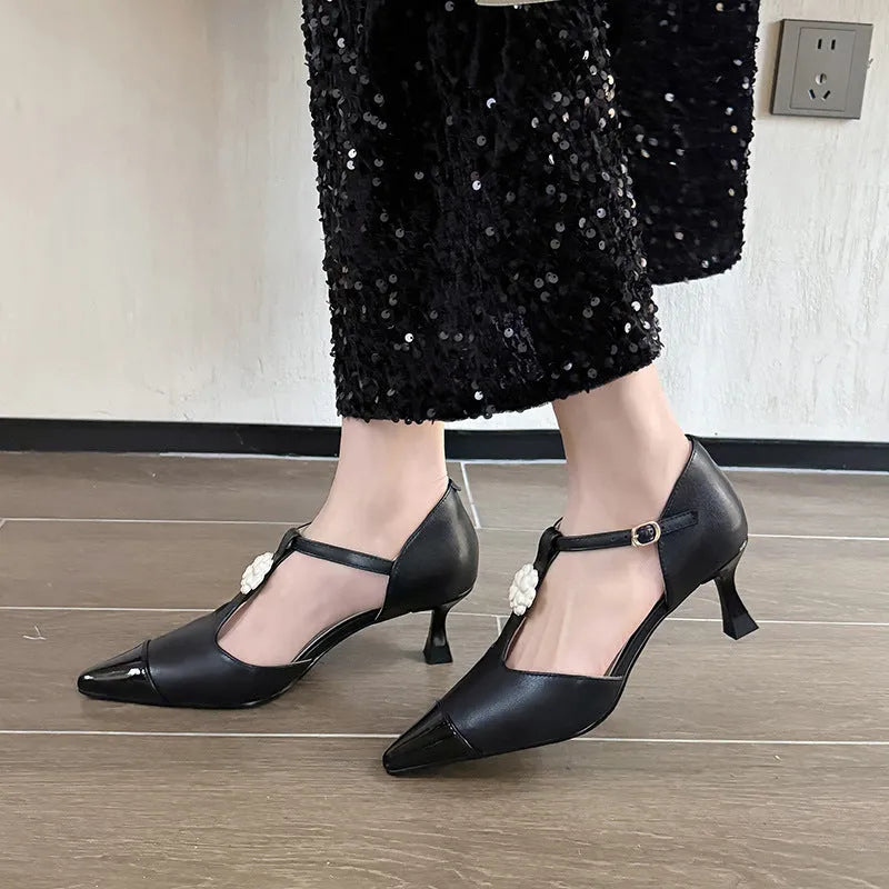 Women's gold stiletto heels with flower decoration, pointed toe, and shallow mouth cut on a beef tendon sole.