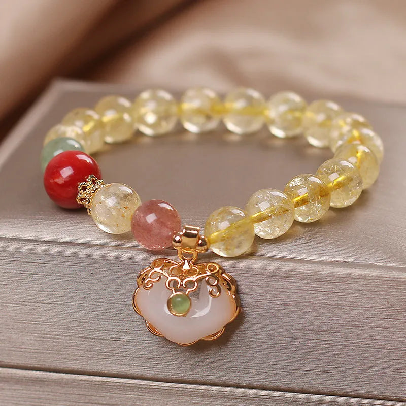Yellow citrine jade ruyi pendant on an alloy women's bracelet.