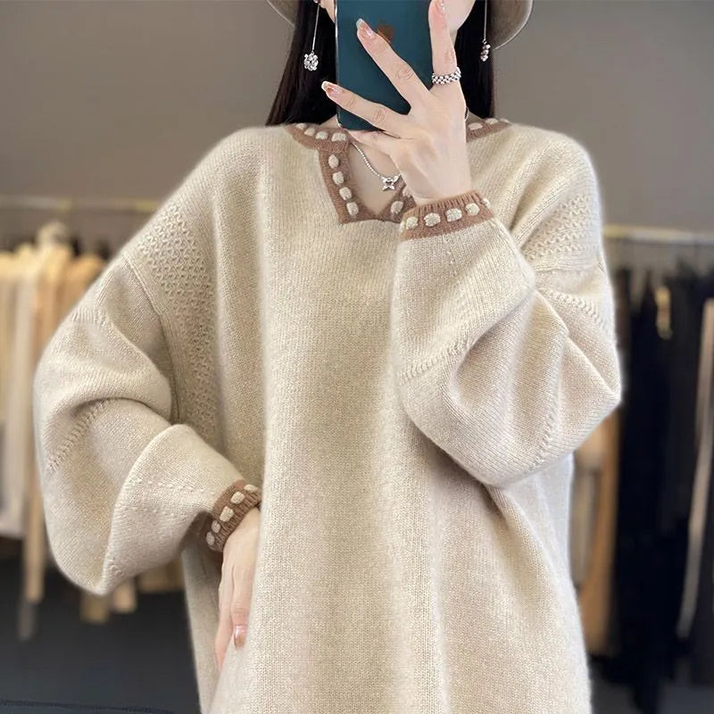 Women's camel coloured V-neck pullover sweater with long sleeves on a hanger.