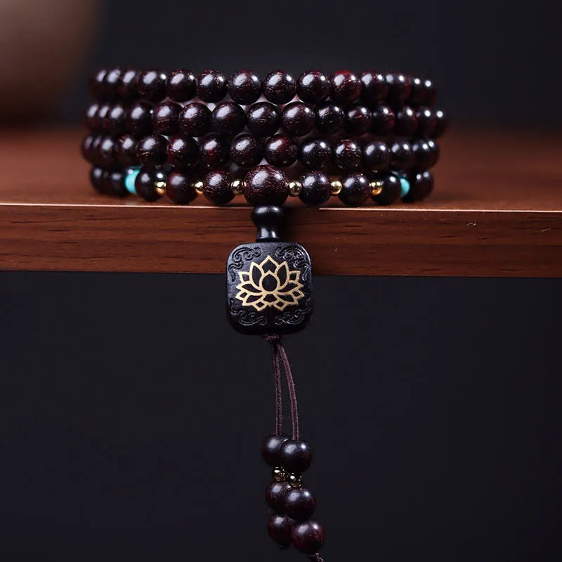 DIY kit showing 108 small 0.6 cm Zambia Rosewood beads for making a flat lotus pendant Buddha bead bracelet.