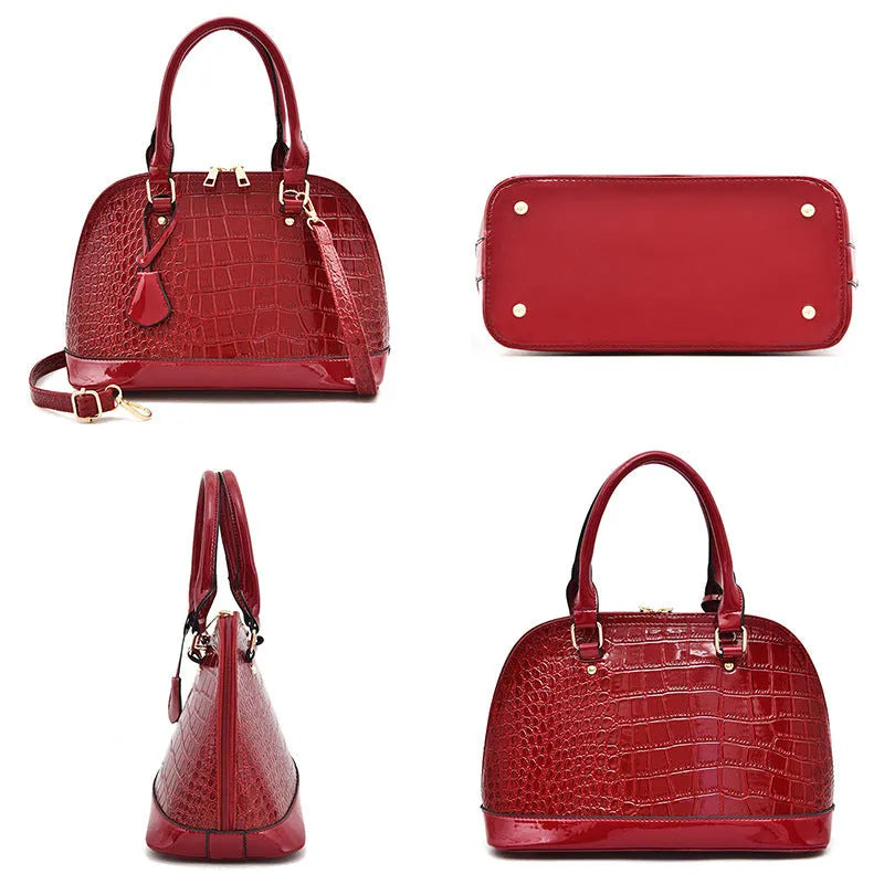 Large shiny PU leather crossbody bag in shell shape design showing black colour option