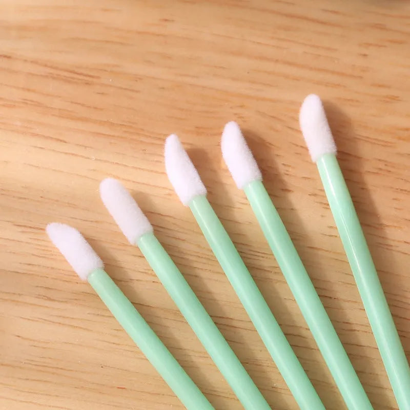 Pack of multi-colour disposable lip brush applicators with black handles and soft flocked tips.