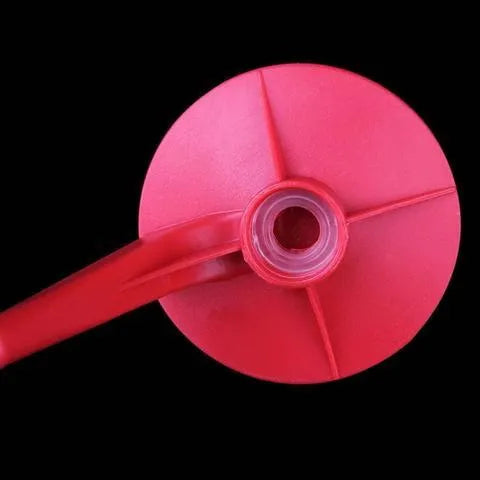 Red plastic Magic Tap soda bottle dispenser attached to a 2-litre bottle.