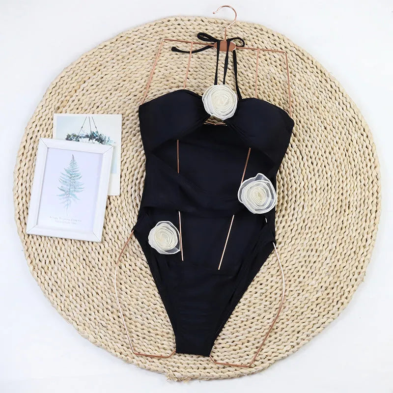 Women's black and blue stripe one-piece swimsuit with 3D floral detail