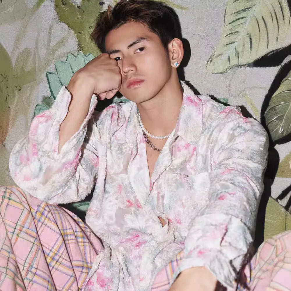 Man wearing a blue floral embossed long sleeve shirt with a loose fit