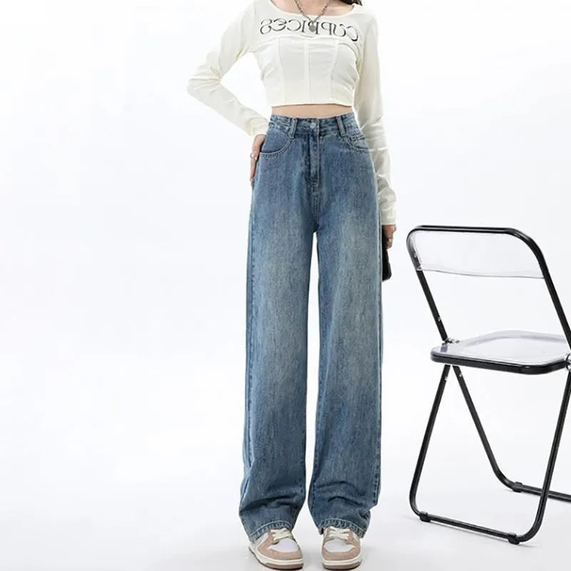 Woman wearing retro blue high waist wide leg jeans with a straight leg cut.