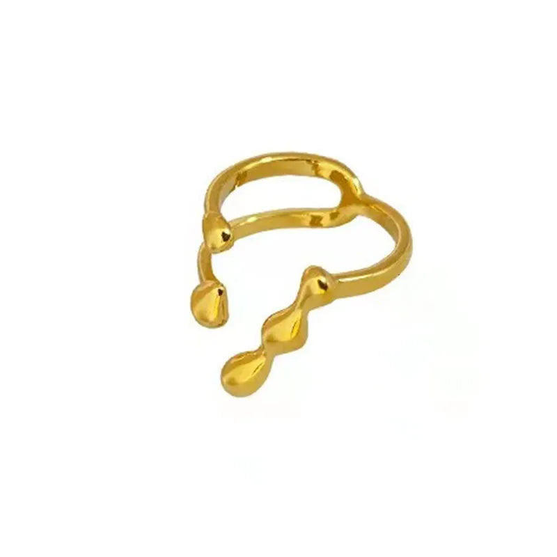 Women's brass open ring with spherical elements in gold finish showing adjustable band design