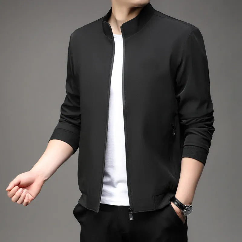 Man wearing a loose fit black Korean style casual jacket with zip pockets.