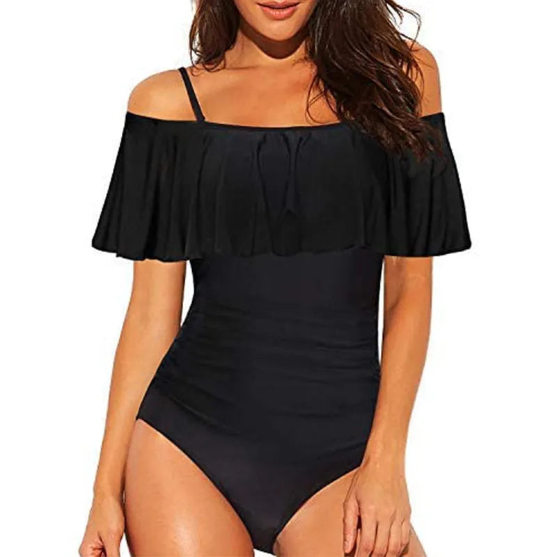 Black one-piece swimsuit with cut-out sides and ruffled shoulder straps on a mannequin.
