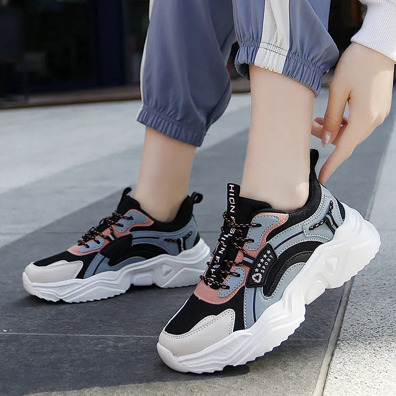 White women's casual sports shoe with mesh upper, thick PU sole, and buckle strap.