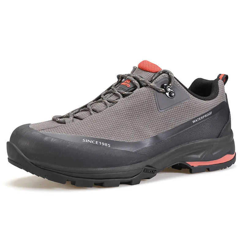 Low-top hiking boots in black with leather mesh upper, rubber outsole, and front lace-up design on a neutral background.