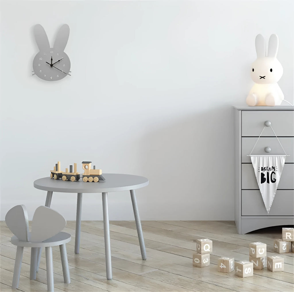 Wooden cartoon wall clock featuring playful alien, rabbit, or swan design in colours like pink or grey.
