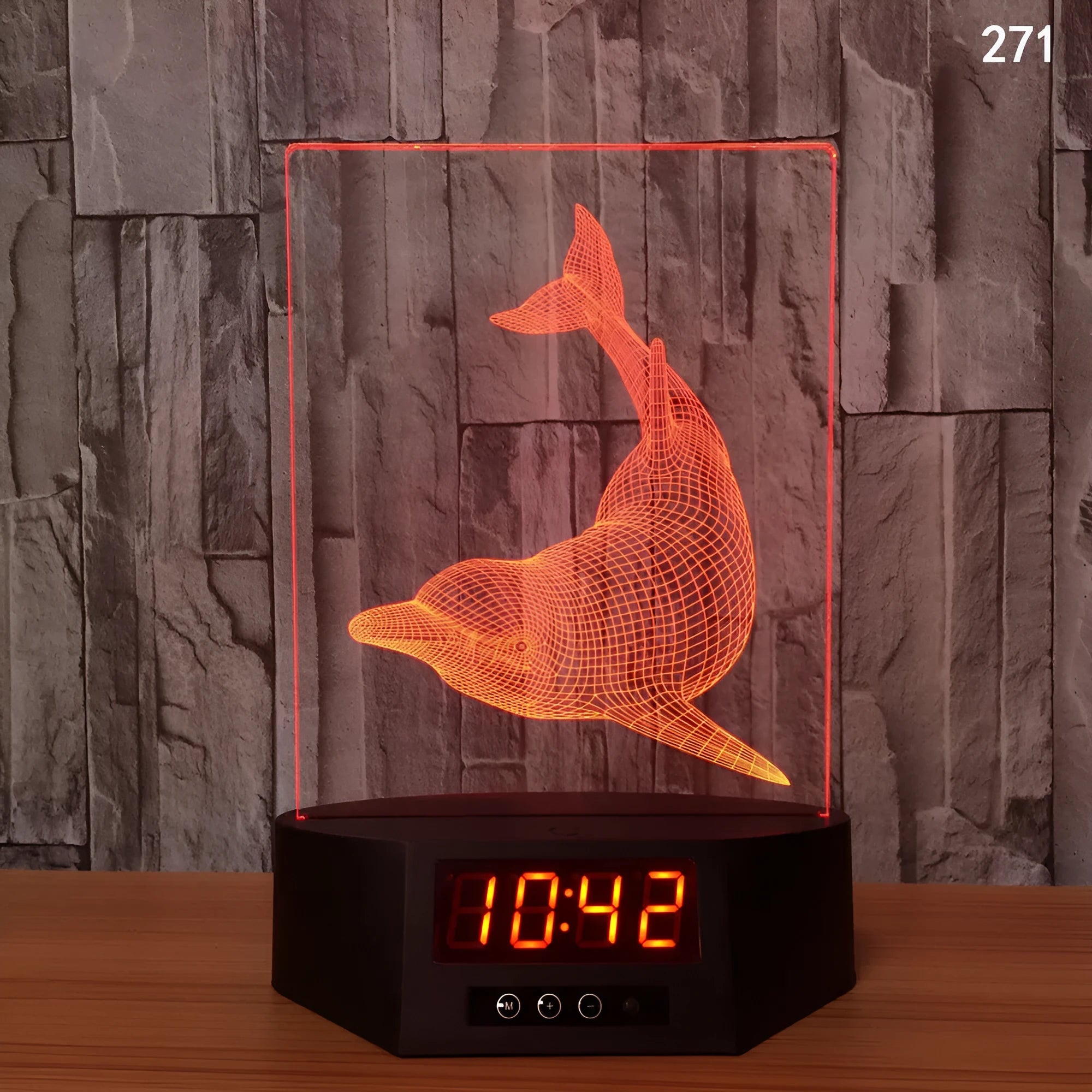 Glowing blue dolphin 3D LED table lamp with remote control on a wooden surface.