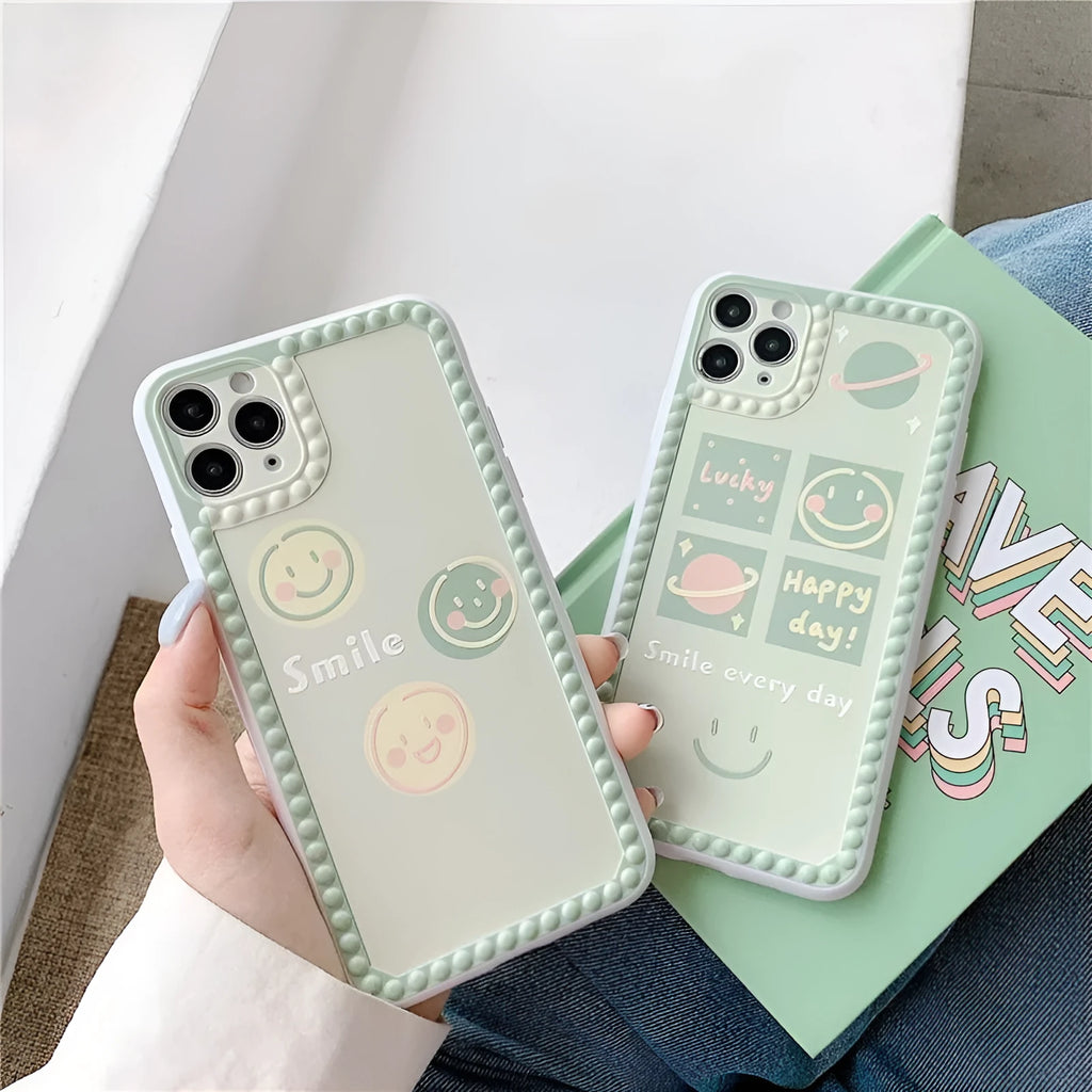 Green TPU iPhone case with smiley face and geometric pattern inside a polka dot frame.