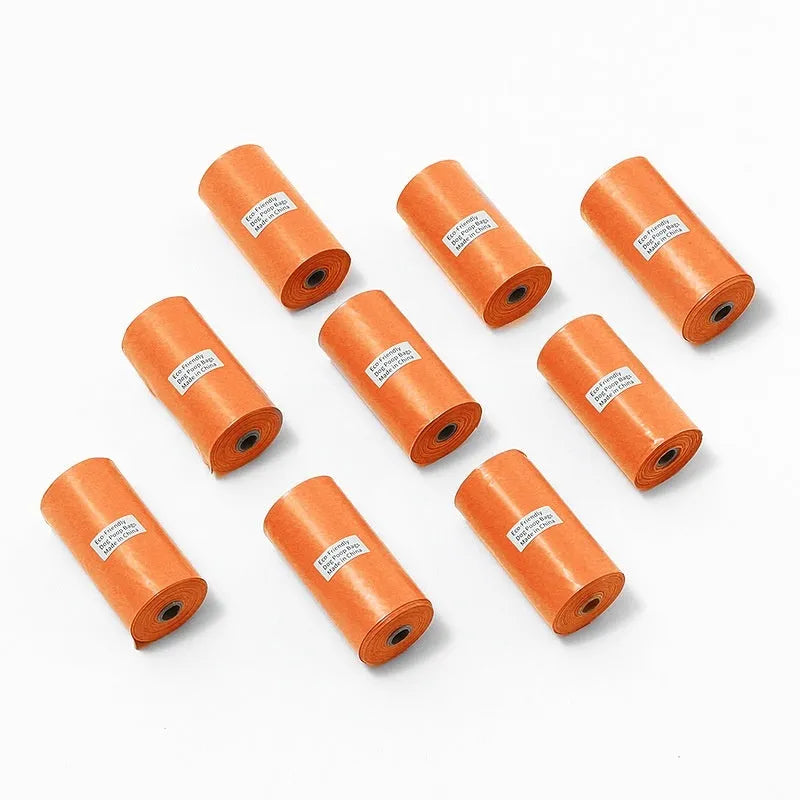 EPI degradable pet waste bag rolls in green, black, blue, and orange colours with a capsule dispenser.