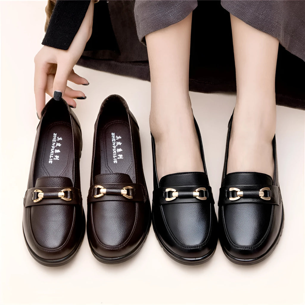 Black casual leather pumps with a soft rubber sole and low flat heel on a white background