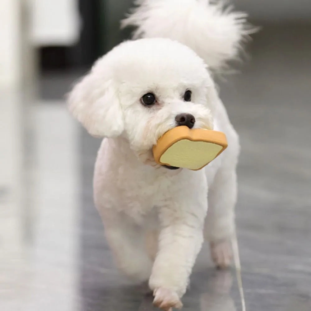 Yellow latex dog chew toy shaped like cartoon bread with egg pattern design
