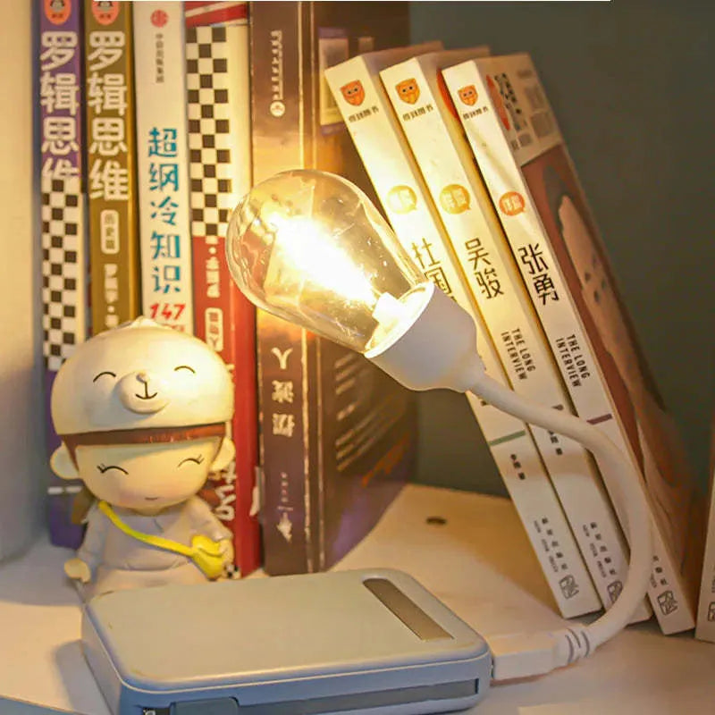 USB rechargeable folding tungsten filament night light in extended position showing warm white illumination