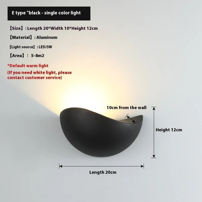 Black bird's nest design LED courtyard lamp with IP65 waterproof rating on a garden wall.