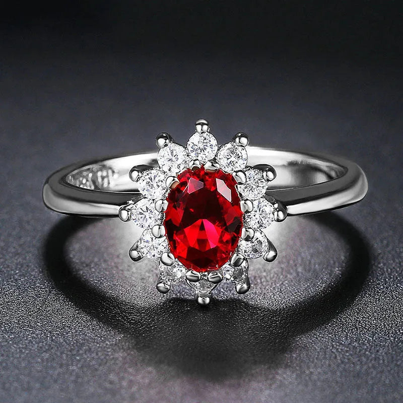 Copper flower-shaped ring with inlaid zirconia available in sapphire blue, green, and pomegranate red colours.