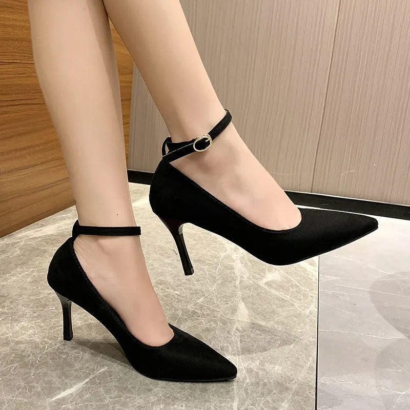 Black women's stiletto pump high heels with a skull-pattern buckle decoration on the front.