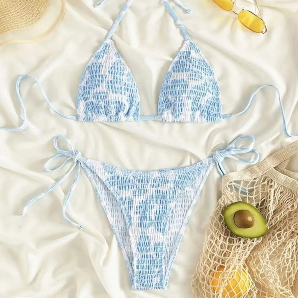 Women's floral pattern halter swimsuit briefs in light blue on a mannequin.