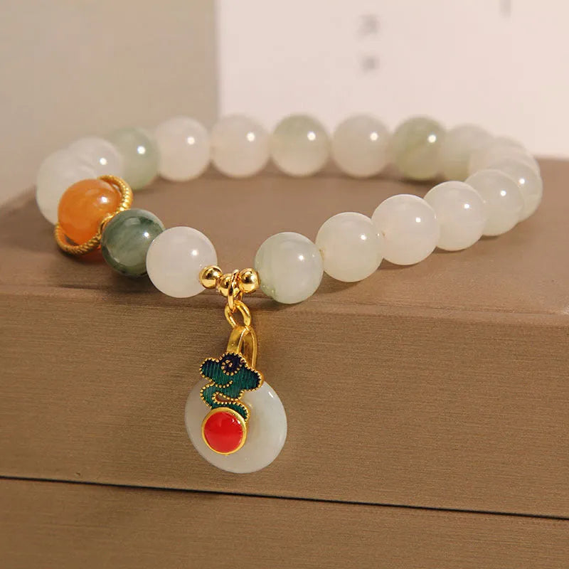 Women's ice jade bracelet with pearl accents and traditional Xiangyun peace buckle closure