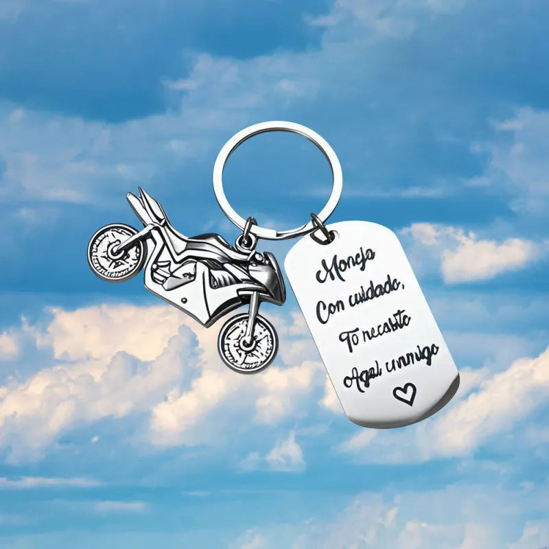 Stainless steel motorcycle key chain with charm and grey flannel storage bag.