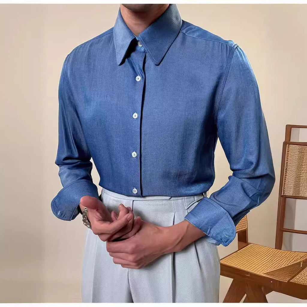 Man wearing a slim fit blue round collar long sleeve shirt made from a rayon and polyester blend.