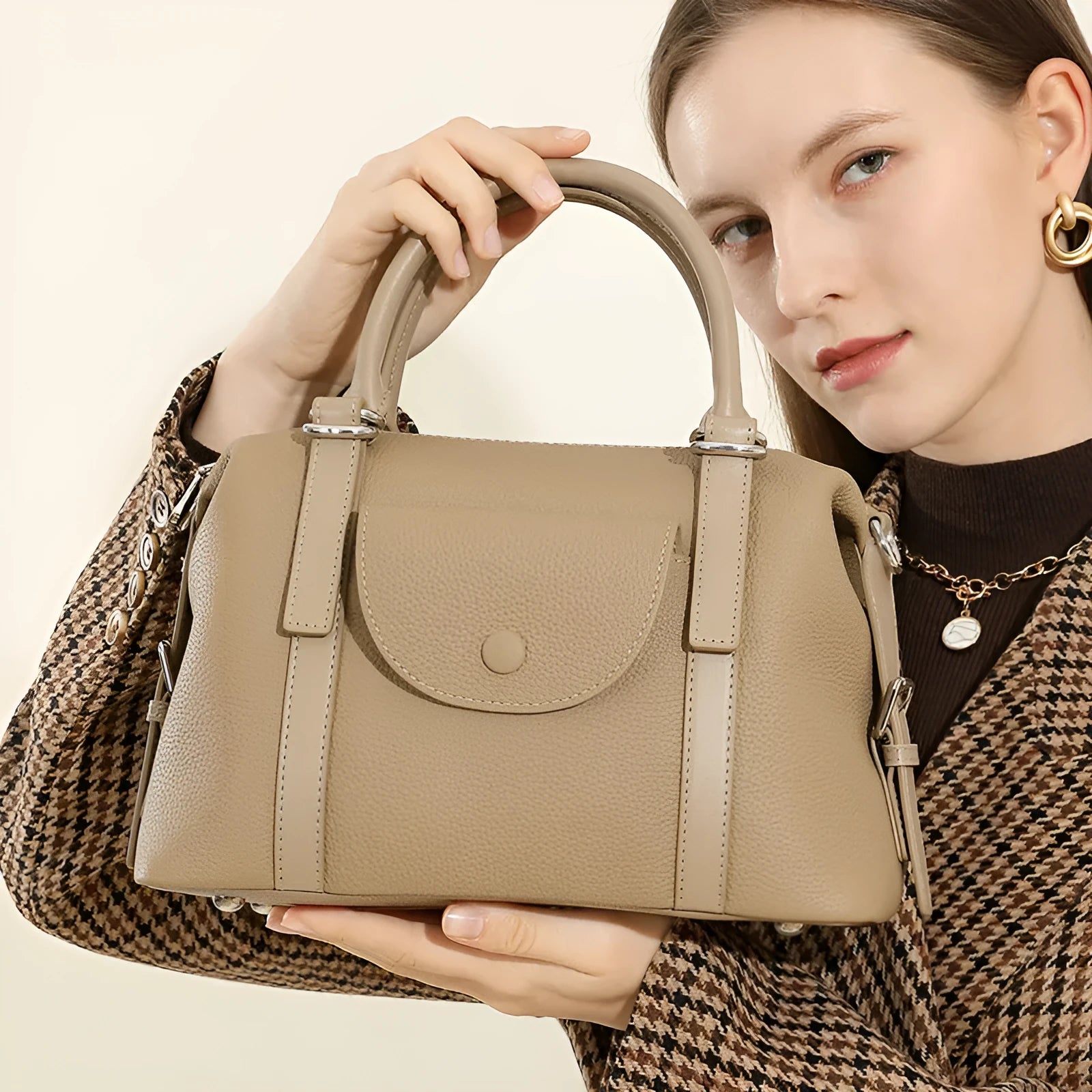 Genuine leather ladies handbag with contrast stitching and lock detail in elephant grey colour